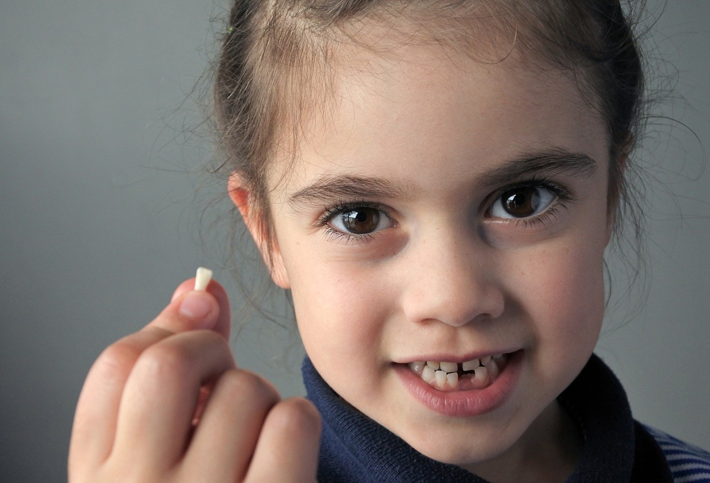 girl-holding-tooth